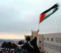 Photo: Jerusalem Bloc supporter waves flag above Birzeit on election night.