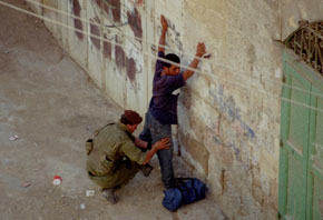 Photo: Palestinian youth being searched outside CPT offices